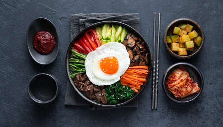 Bibimbap on a dark concrete background, traditional korean dish, top viewの写真素材