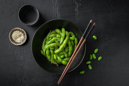 steamed edamame, soybeans on a black background, view from aboveの写真素材