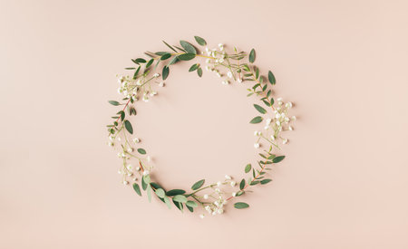 wreath of branches and flowers, creative botanical background, frame, space for textの写真素材
