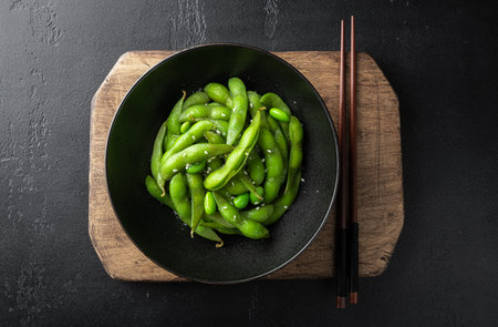 steamed edamame, soybeans on a black background, view from aboveの写真素材