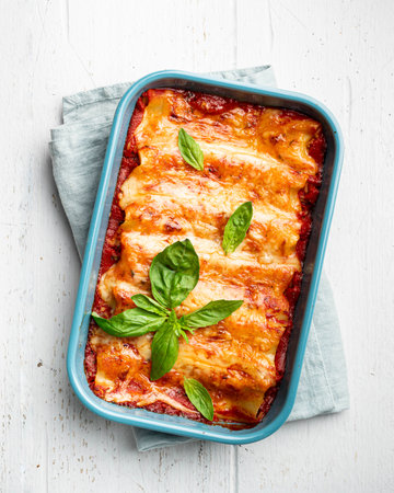 Cannelloni on white wooden background, italian cuisine, top viewの写真素材