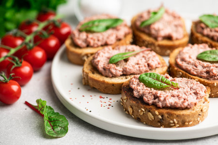 bruschetta with liver pate on a white ceramic plate , selective focusの写真素材