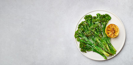roasted broccolini on a light concrete background, copy space, top viewの写真素材