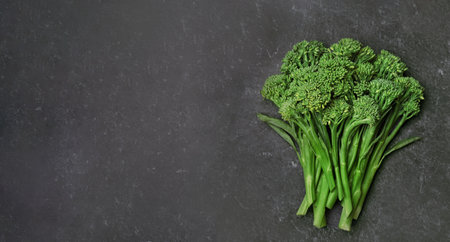 raw broccolini on a black background, top view, copy spaceの写真素材