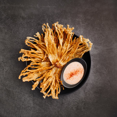 Fried Enoki Mushrooms with sauce on black background, top viewの写真素材