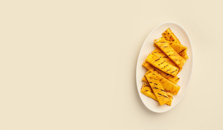 Summer fruit snack, Grilled pineapple, on a light beige monochrome background, top view, copy spaceの写真素材