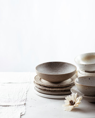 handmade ceramics, empty craft ceramic bowls and plates on light backgroundの写真素材