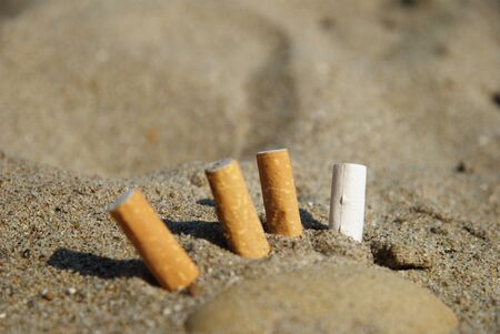 cigarette butts in the sand