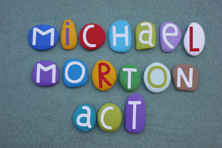 Colorful wooden letters on a grey background.
