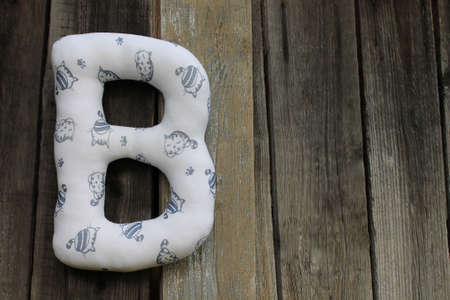 Textile letter with cats on wooden backgroundの写真素材