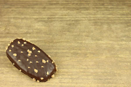 Biscuit with chocolate icing on wooden backgroundの写真素材