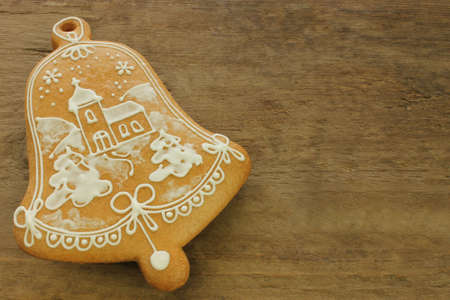 Decorated gingerbread with white pattern on wooden backgroundの写真素材