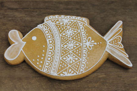 Decorated gingerbread with white pattern on wooden backgroundの写真素材