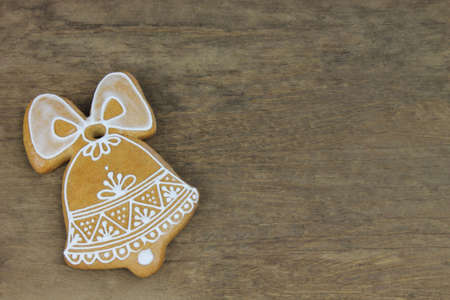 Decorated gingerbread with white pattern on wooden backgroundの写真素材