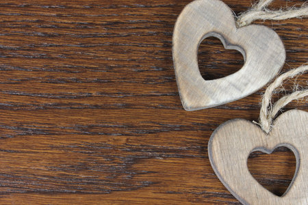 Wooden hearts in detail on dark wooden backgroundの写真素材