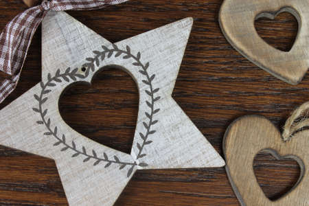 Wooden hearts in detail on dark wooden backgroundの写真素材