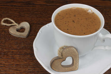 Cup of hot chocolate with hearts on dark wooden backgroundの写真素材