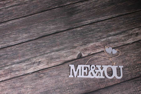Grey letters me and you with little hearts on wooden backgroundの写真素材