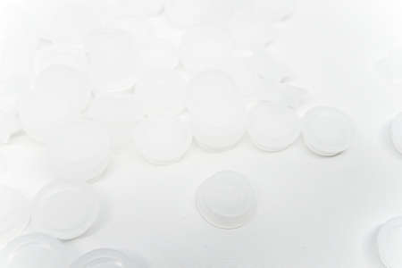 Round disposable fat glue containers made of plastic for eyelash extension treatment on white background.の写真素材