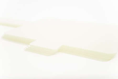 Close-up shot of a pile of white thick papers for headband in eyelash extension treatment.の写真素材