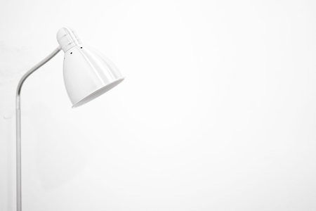 Stainless steel eyelash lamp in a white wall room of a parlor or salon.