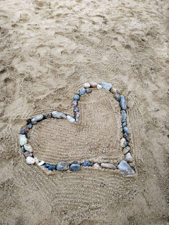 Heart of stones on Italian beachの写真素材