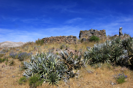 The pre-inca ruins of Maukallacta on the mountain over Puica a peruvian mountain village over the cliffs of the beautiful Cotahuasi Canyonの写真素材