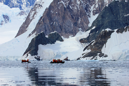 Inflatable boat full of tourists, watching for whales and seals, Antarctic Peninsula, Antarcticaの写真素材