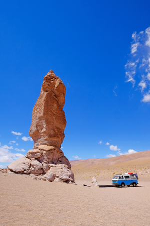 Old german vintage campervan at stone formation Pacana Monks, Monjes De La Pacana, The Indian Stone, near Salar De Tara, Los Flamencos National Reserve, Atacama Desert, Chile, South Americaの写真素材