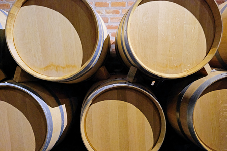 Oak wine barrels stacked in the cellar of a Malbec winery factory in San Juan, Argentina, South America, also seen in Mendozaの写真素材