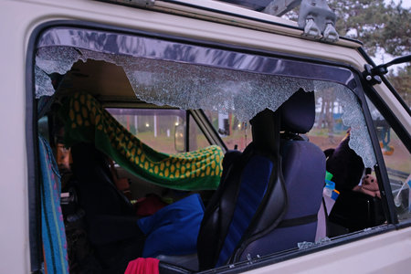 Smashed passenger window of a camper van, goods stolen and interior vandalized, burglary and...