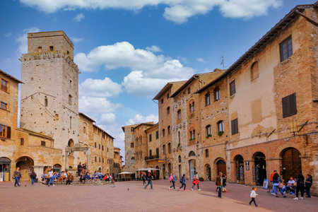San Gimignano, Tuscany, Italy, April 02, 2019: Tourists at the famous Piazza Della Cisterna square in the historic town of San Gimignano, Tuscany, Italy, Europeのeditorial素材