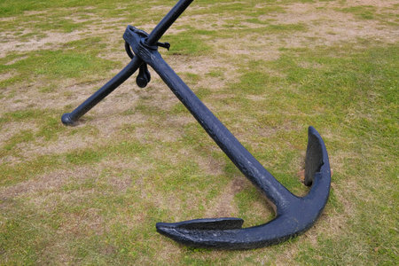 Old marine ship anchor lying on a meadow at the port of Montevideo, Uruguay, South America