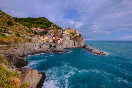 Colorful traditional houses on the rock over Mediterranean sea, Manarola, Cinque Terre, Italy, Europeの写真素材