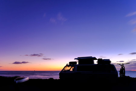Old vintage van by the sea at sunset, Civitavecchia, Lazio, Italy