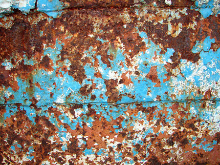 Peeled paint on rusted metal sheet                