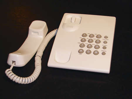 White telephone on black background with handset offの写真素材