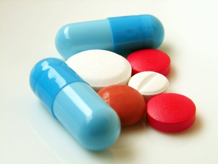 mixed pills on white background      の写真素材