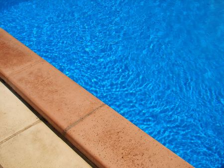 part of swimming pool with clear blue water        の写真素材