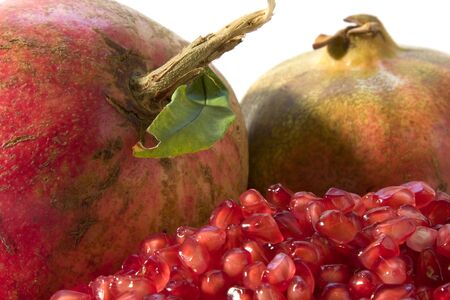 Red ripe pomegranates with  grain  on white backgroundの写真素材