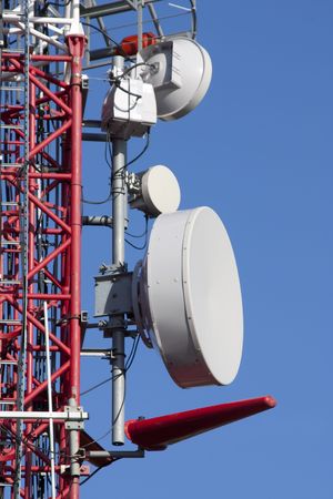 Few different  antenna dishes on telecommunications towerの写真素材