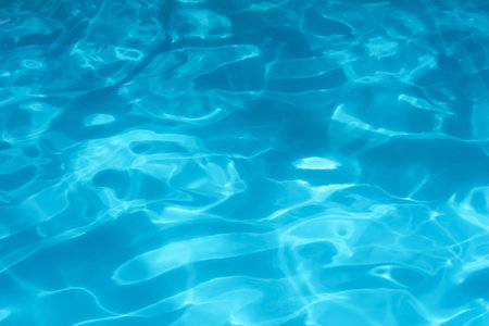 Blue rippled swimming pool water surface at night