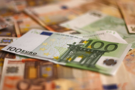 Hundred Euros on euros background shallow DOF