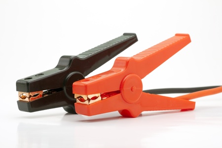Pair of Red and Black Clamps of Jumper Cable on White Backgroundの写真素材