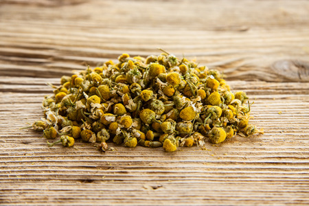 Dry camomile flower  on old wooden tableの写真素材