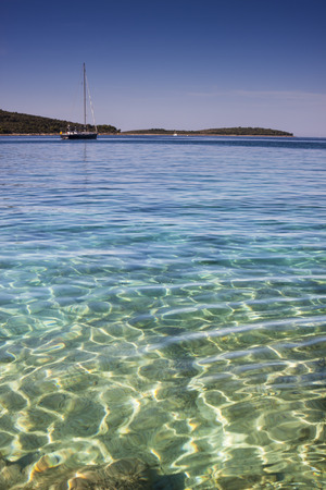 Sailing Boat in beautiful crystal clear seaの写真素材