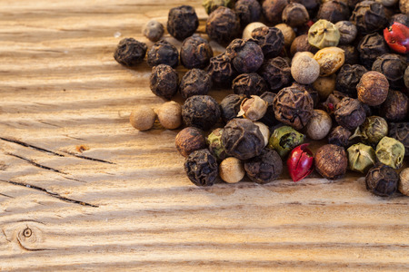 Dry  peppercorn mix  on wooden background macroの写真素材