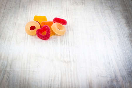 Colorful Jelly Candy on white wooden background close upの写真素材