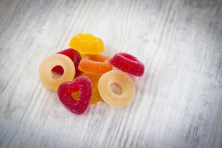 Colorful Jelly Candy on white wooden background close upの写真素材