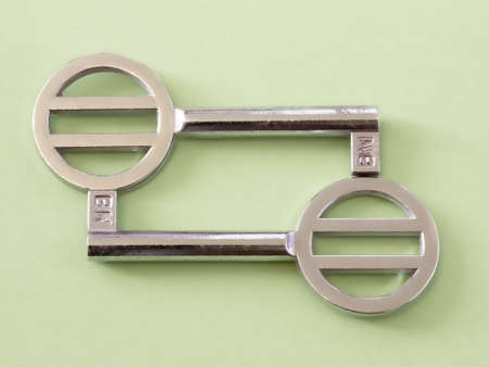 two chrome shiny simple door keys stay face to faceの写真素材
